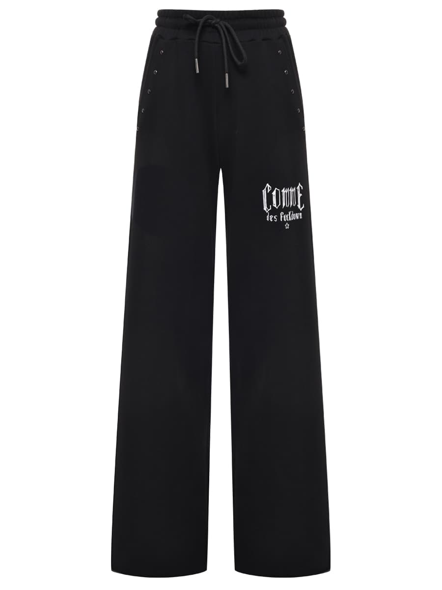 Comme Des Fuckdown Pantaloni felpa stampa e borchie